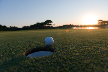 Image showing golf ball on edge of  the hole