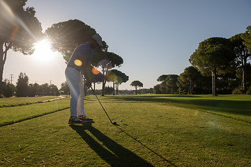 Image showing golf player hitting shot