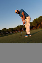 Image showing golfer  hitting shot at golf course