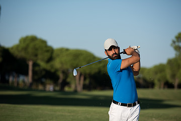 Image showing pro golfer hitting a sand bunker shot