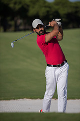 Image showing golfer hitting a sand bunker shot