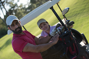 Image showing couple in buggy on golf course