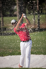 Image showing golfer hitting a sand bunker shot