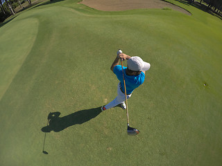 Image showing top view of golf player hitting shot