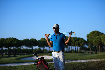 Image showing golfer  portrait at golf course on sunset