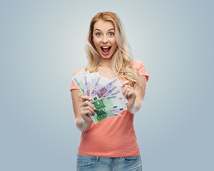 Image showing happy young woman with euro cash money