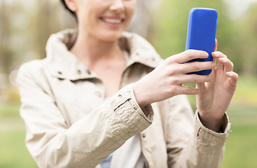 Image showing close up of woman taking picture with smartphone