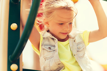 Image showing happy little girl climbing on children playground