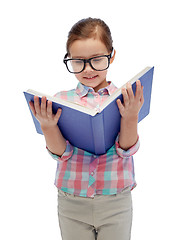 Image showing happy little girl in eyeglasses reading book