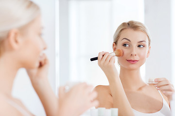 Image showing woman with makeup brush and powder at bathroom