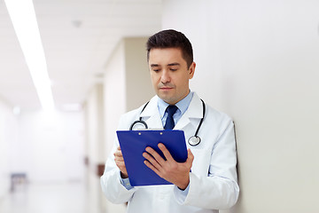 Image showing doctor with clipboard at hospital corridor