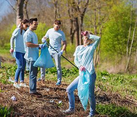 Image showing volunteers with garbage bags cleaning park area