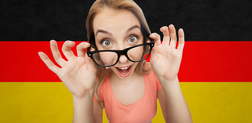 Image showing happy young woman or teenage girl in eyeglasses