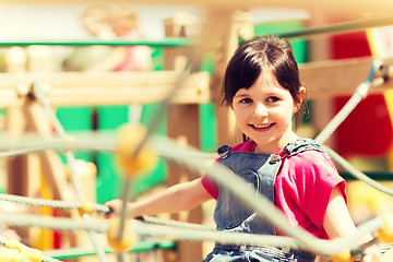 Image showing happy little girl climbing on children playground