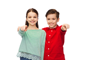 Image showing happy boy and girl pointing finger to you