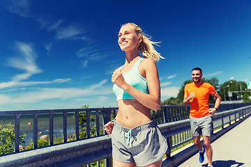 Image showing smiling couple running at summer seaside