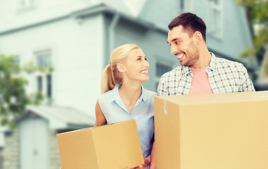 Image showing couple with cardboard boxes moving to new home