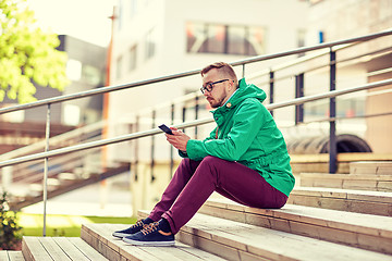 Image showing young hipster man with smartphone in city