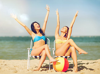 Image showing girls sunbathing on the beach chairs