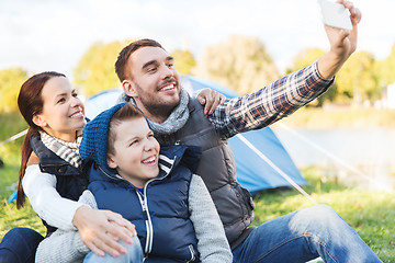 Image showing family with smartphone taking selfie at campsite