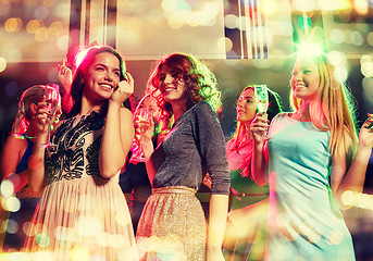 Image showing smiling friends with glasses of champagne in club