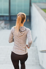 Image showing close up of sporty woman running downstairs