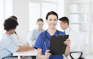 Image showing happy doctor over group of medics at hospital