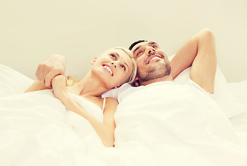 Image showing happy couple lying in bed at home