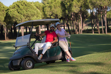 Image showing couple in buggy on golf course