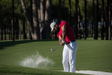 Image showing golfer hitting a sand bunker shot