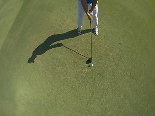 Image showing top view of golf player hitting shot