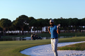 Image showing golfer  portrait at golf course on sunset