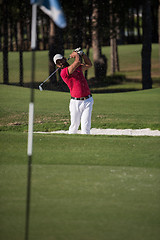 Image showing golfer hitting a sand bunker shot