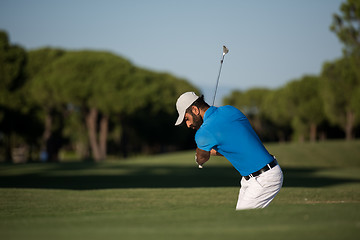 Image showing pro golfer hitting a sand bunker shot