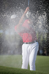 Image showing golfer hitting a sand bunker shot