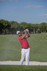 Image showing golfer hitting a sand bunker shot