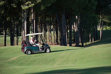 Image showing couple in buggy on golf course