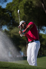 Image showing golfer hitting a sand bunker shot