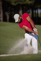 Image showing golfer hitting a sand bunker shot