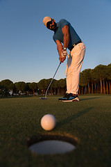 Image showing golfer  hitting shot at golf course