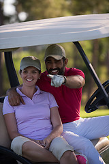 Image showing couple in buggy on golf course