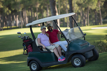 Image showing couple in buggy on golf course