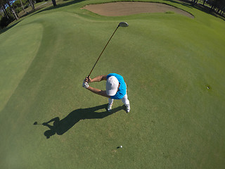 Image showing top view of golf player hitting shot