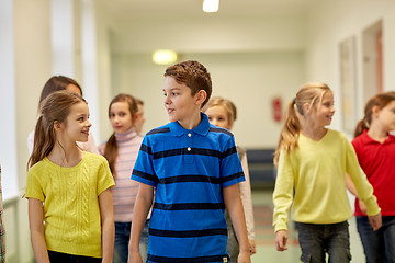 Image showing group of smiling school kids walking in corridor