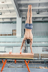 Image showing The sportsman during difficult exercise, sports gymnastics