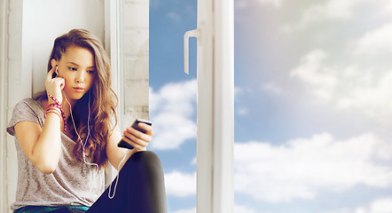 Image showing teenage girl with smartphone and earphones