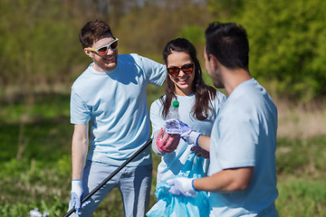 Image showing volunteers with garbage bags cleaning park area