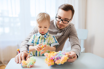 Image showing father and son playing with ball clay at home