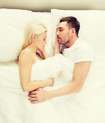 Image showing happy couple sleeping in bed at home