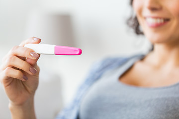 Image showing close up of happy woman with home pregnancy test